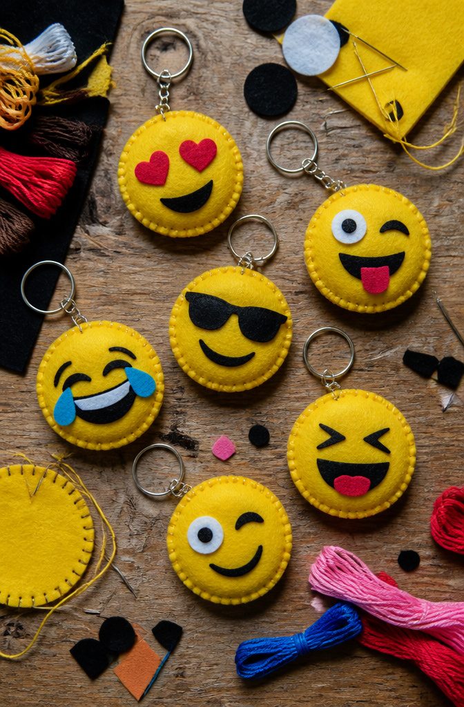 A collection of felt emoji keychains in various expressions.