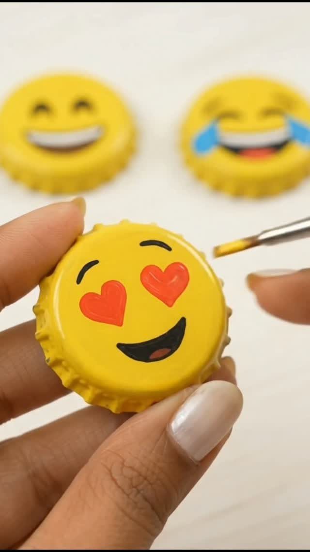 24 Art from Bottle Caps Ideas for Home, Gifts and Play 16 Hand painting a heart-eyes emoji on a yellow metal bottle cap.