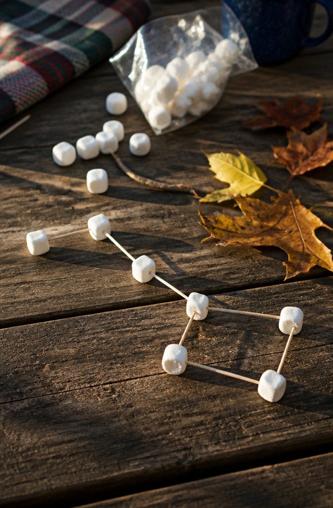 Marshmallows arranged in the shape of constellations on a table.