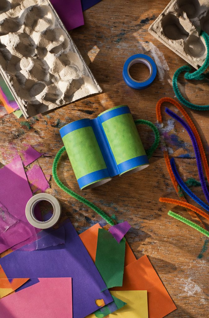 Two toilet paper rolls taped together, ready for crafting binoculars.