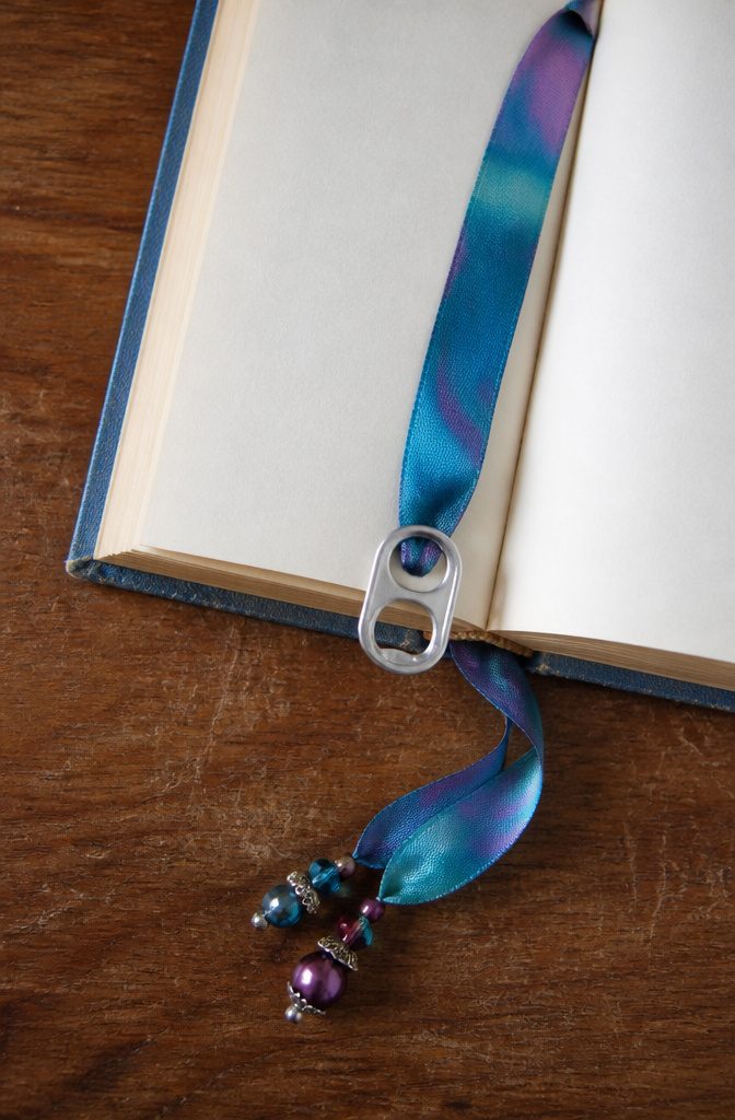 20 Crafts to Do With Soda Tabs: Easy Pop Tab Ideas 4 A bookmark made with a soda tab and ribbon.