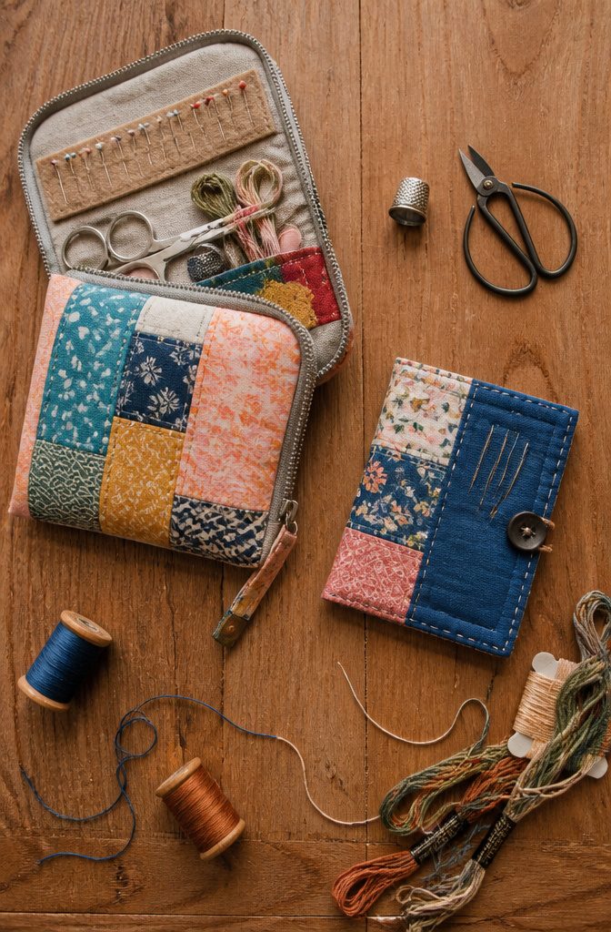 Travel sewing kit showing scissors, thread, and a needlebook.