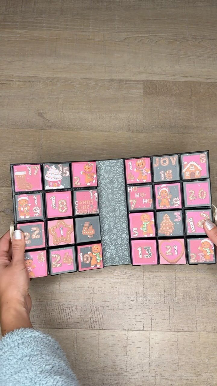 23 DIY Decor with Paper Projects for Every Room 18 Handmade advent calendar with pink and grey paper boxes on a wooden floor.