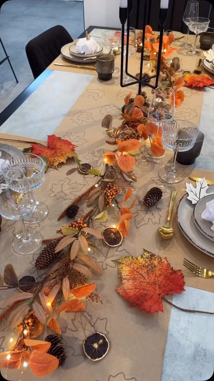 23 DIY Decor with Paper Projects for Every Room 5 Brown kraft paper table runner decorated with autumn leaves, pinecones, and fairy lights.