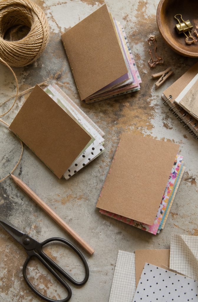 Several mini notebooks made from paper scraps and a cardboard cover.