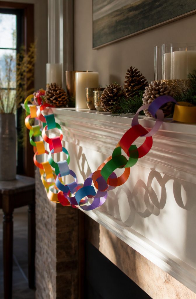 Vivid paper chains made from construction paper decorating a mantelpiece.