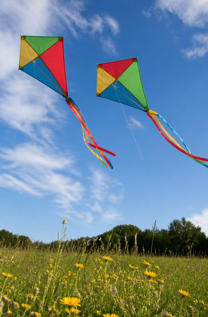 A diamond paper kite assembled with light sticks for flying outdoors.