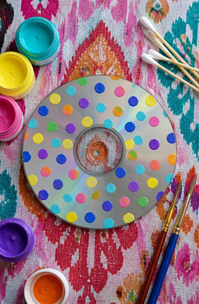 A CD decorated with various colored polka dots.