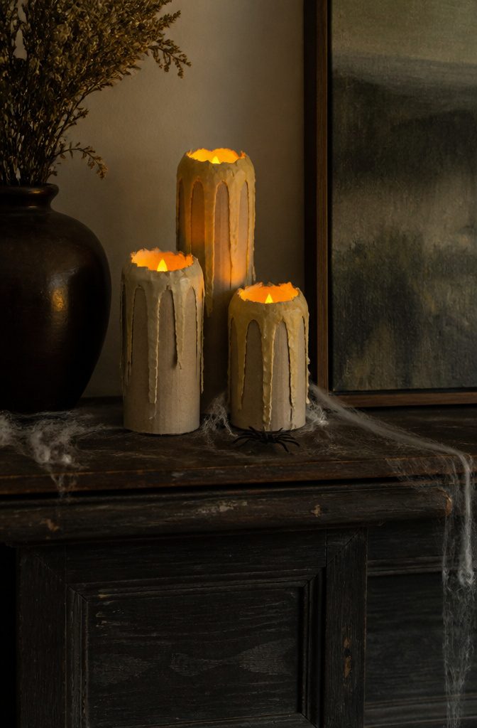 25 Ideas to Make Stuff Out of Cardboard at Home 4 Three paper tube candles with drips and LED lights on a mantel.