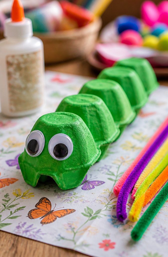An egg carton caterpillar with googly eyes and pipe cleaner antennae.