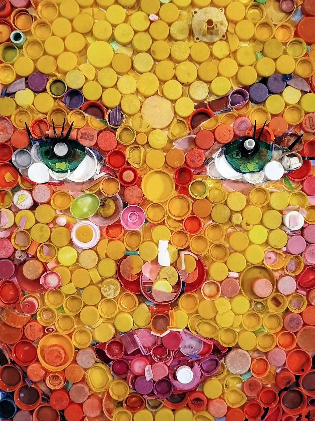17 Recycled Art Projects for Kids and Adults to Make 6 Mosaic face portrait made from colorful plastic bottle caps in yellow and red tones.