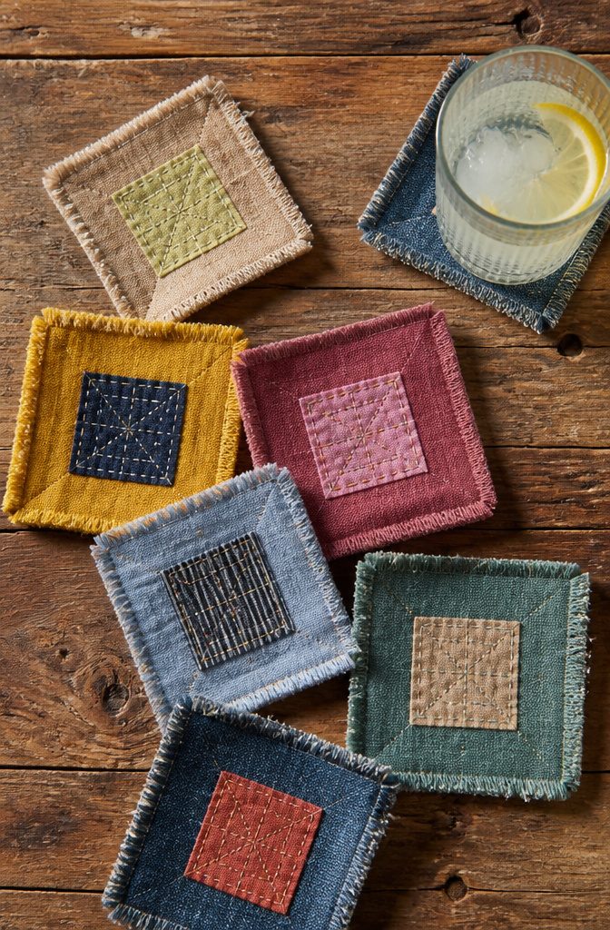 Set of fabric coasters in various colors, featuring frayed edges.