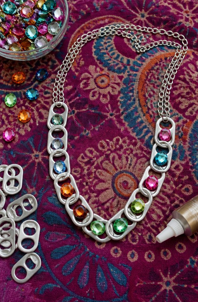Necklace made from soda can tabs and decorated with gemstones.