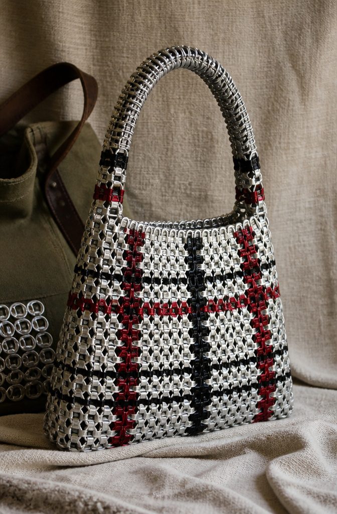 Purse constructed entirely from linked soda can tabs.