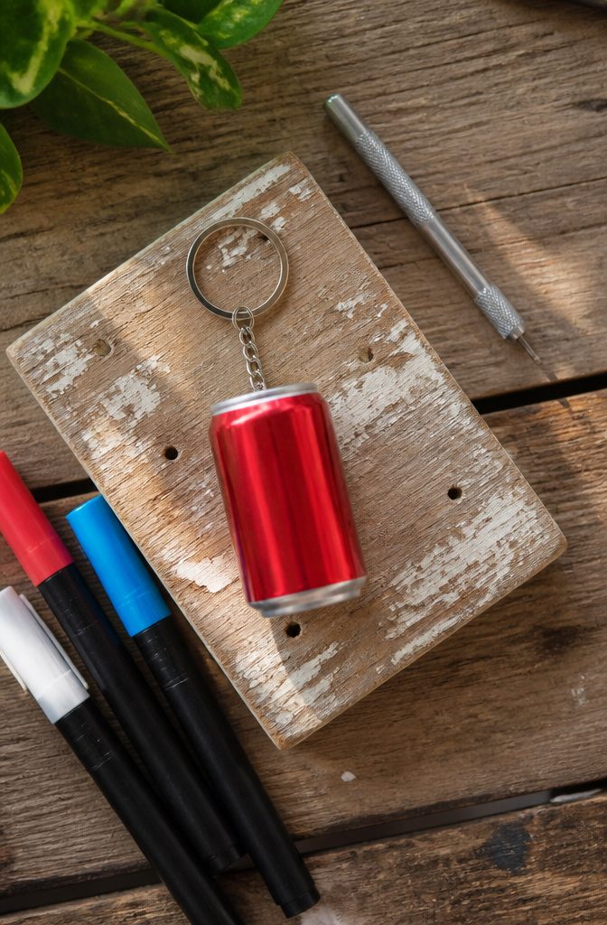 Soda can keychain cut into a circular shape with a hole for a ring.