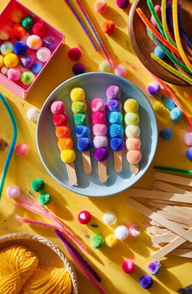 25 Unique Craft Ideas: Robots, Puppets, Paints & More 7 Colorful pompoms glued to craft sticks resembling ice pops.
